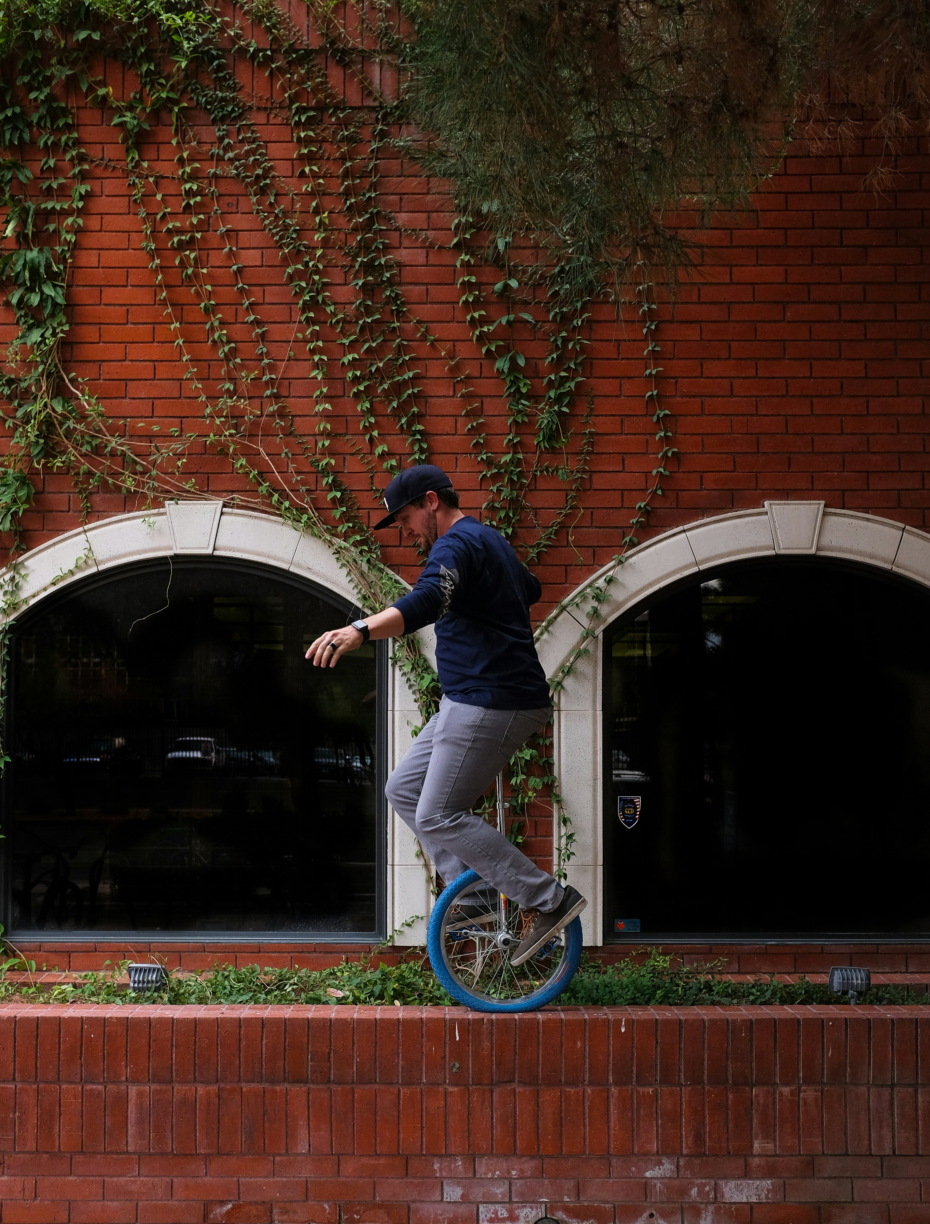 man riding unicycle near wall